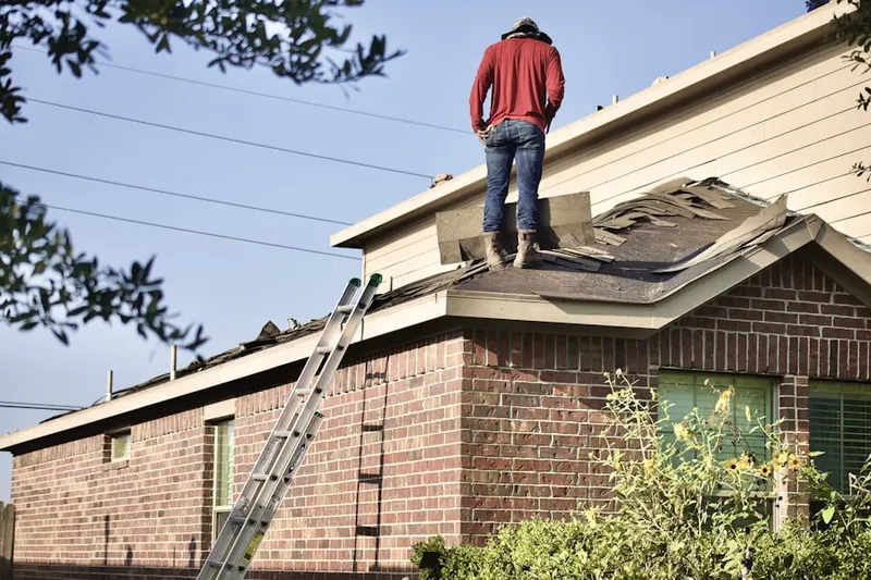 Professional roofer working on a residential roof in Bellefontaine